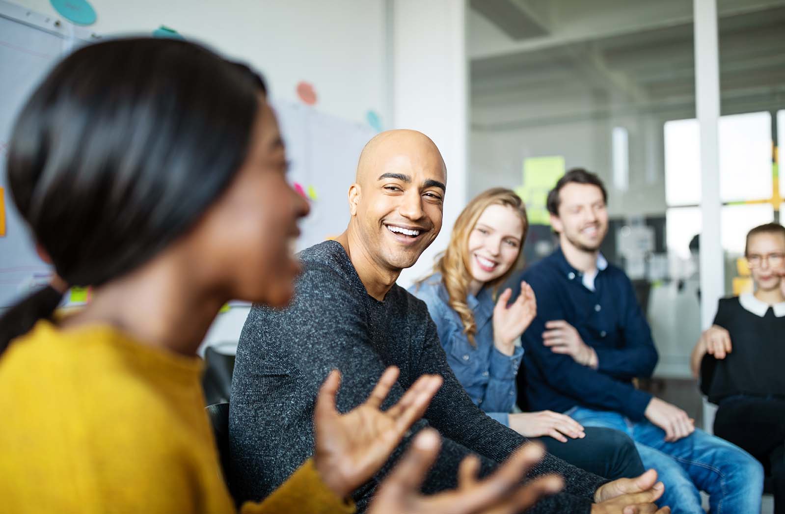 Smiling business people have a company meeting in a shared space